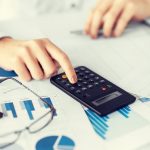 woman-hand-with-calculator-and-papers